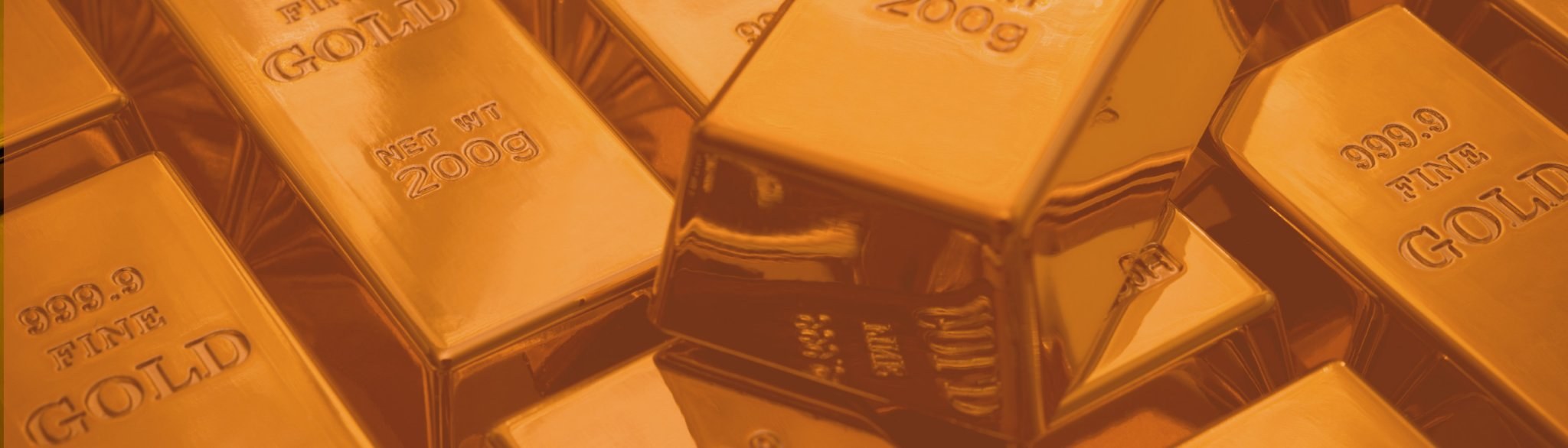 Stacked 999.9 fine gold bars in a secure vault