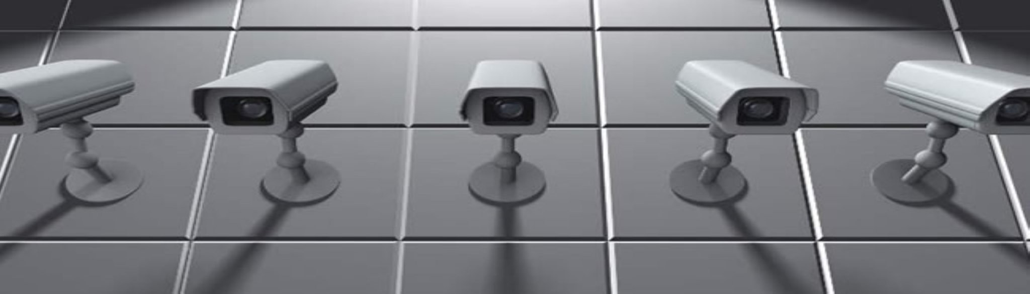 Bank of surveillance cameras monitoring a facility
